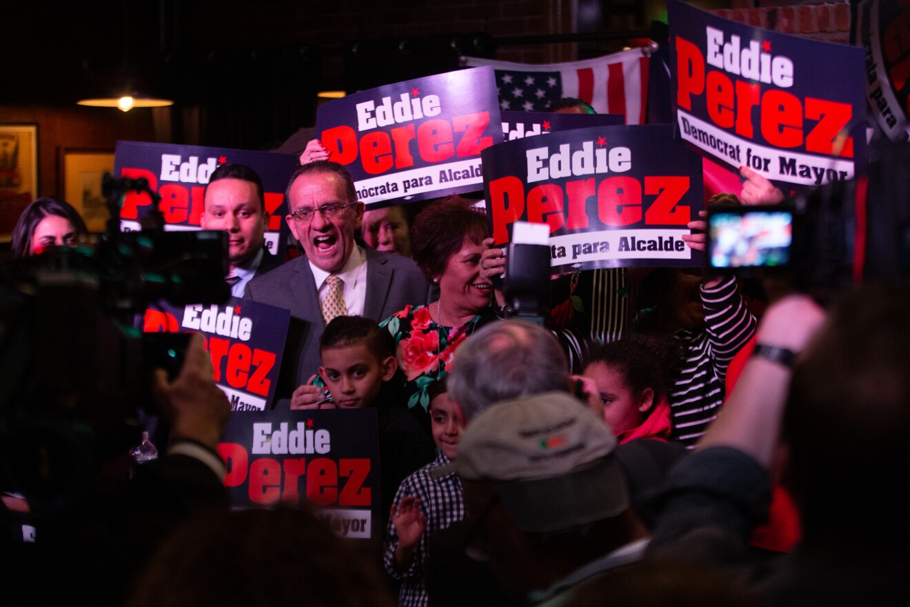 Eddie Perez surrounded by supporters Thursday night.